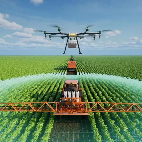 Image of a drone working in an open field along with other farm vehicles.